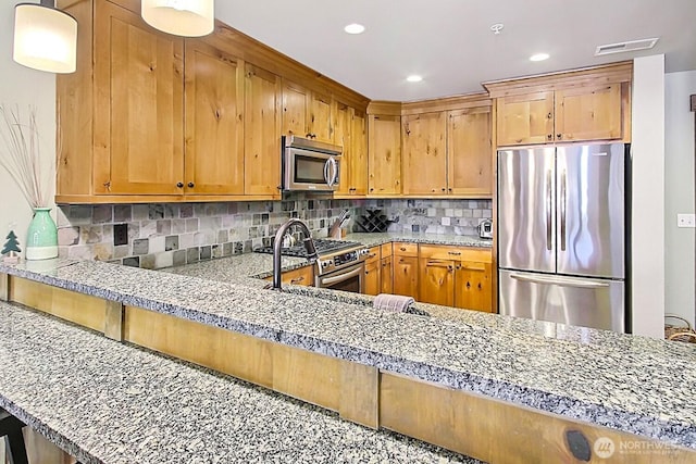 kitchen featuring visible vents, decorative backsplash, light stone counters, stainless steel appliances, and recessed lighting