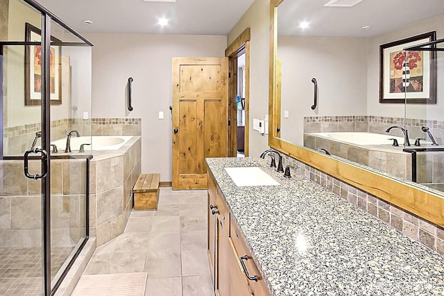 full bath with tile patterned flooring, a garden tub, a shower stall, and vanity