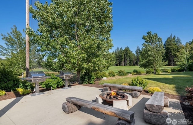 view of patio / terrace with a fire pit and grilling area