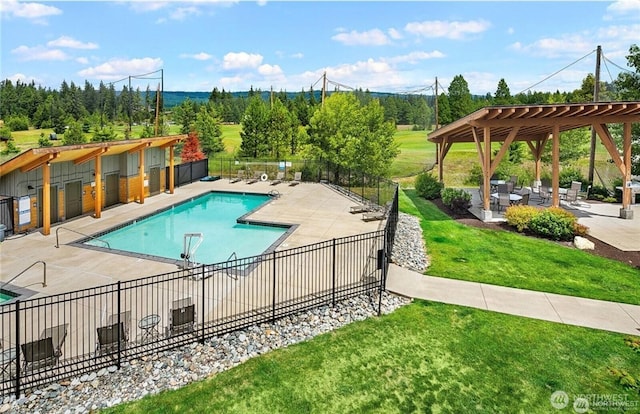 community pool featuring a lawn, fence, and a pergola