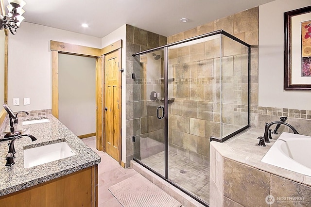 bathroom with a garden tub, a sink, and a shower stall