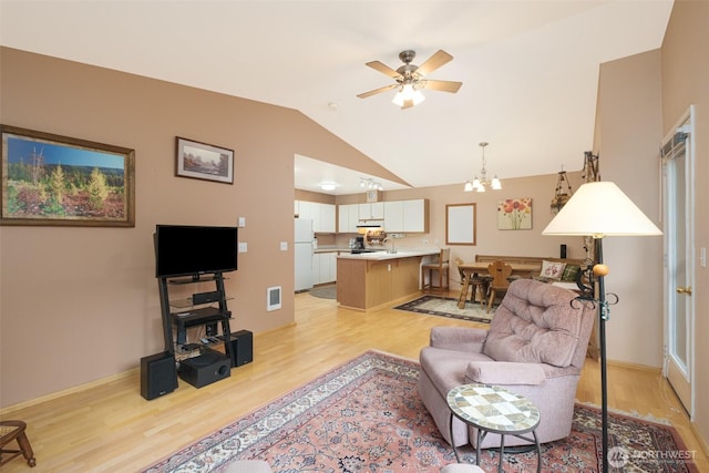 living room featuring visible vents, lofted ceiling, ceiling fan with notable chandelier, and light wood finished floors