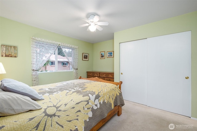 bedroom with carpet, a closet, and ceiling fan