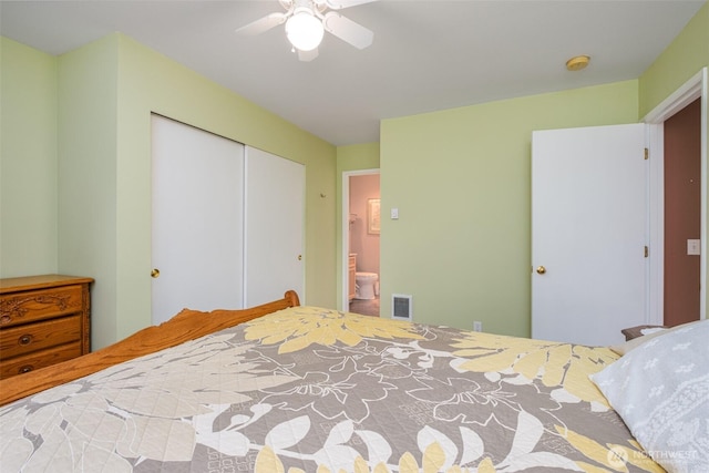 bedroom with visible vents, ensuite bath, a closet, and ceiling fan