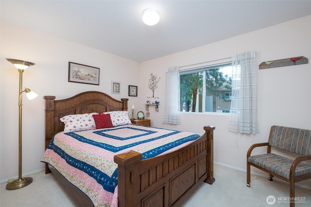 bedroom featuring light colored carpet and baseboards