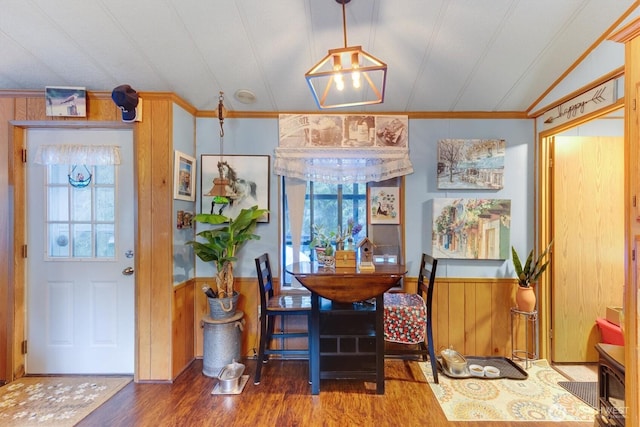 dining area with ornamental molding, wainscoting, wood finished floors, and a healthy amount of sunlight