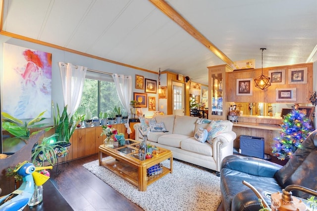 living room with lofted ceiling with beams, ornamental molding, and wood finished floors