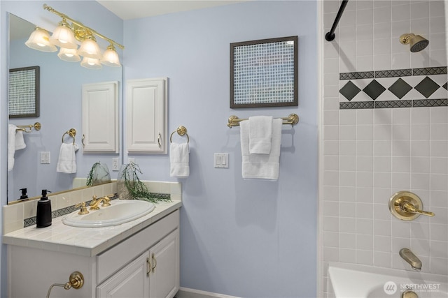 bathroom with washtub / shower combination and vanity