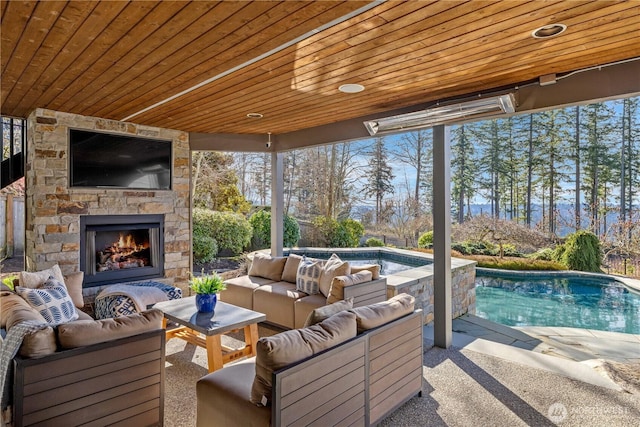 exterior space featuring an outdoor living space with a fireplace and an outdoor pool