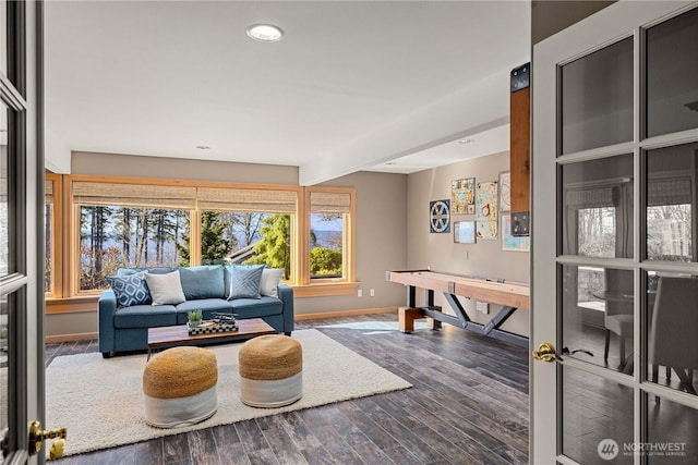 living area with recessed lighting, wood finished floors, and baseboards