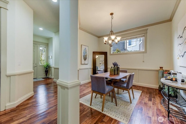 dining space with dark wood-style floors, plenty of natural light, wainscoting, and ornamental molding