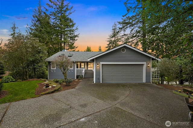 ranch-style home with a garage and driveway