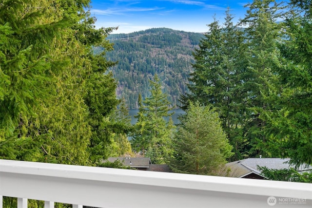 view of mountain feature featuring a water view and a view of trees