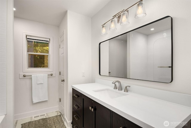 bathroom featuring baseboards, visible vents, and vanity