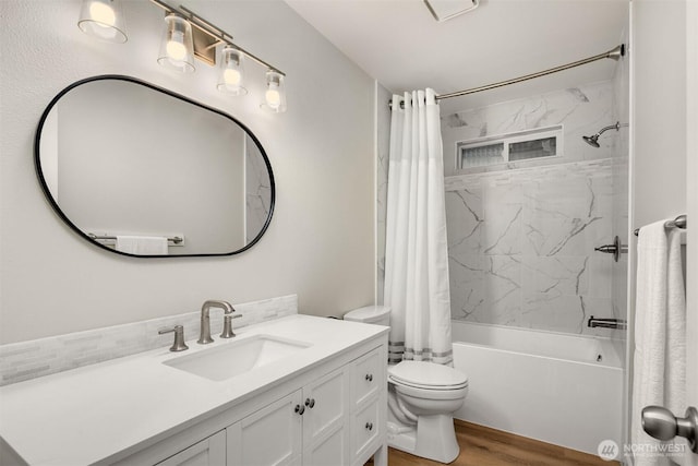 bathroom featuring toilet, shower / bath combo, wood finished floors, and vanity