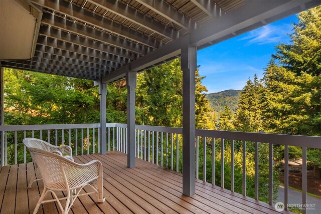 wooden deck featuring a mountain view