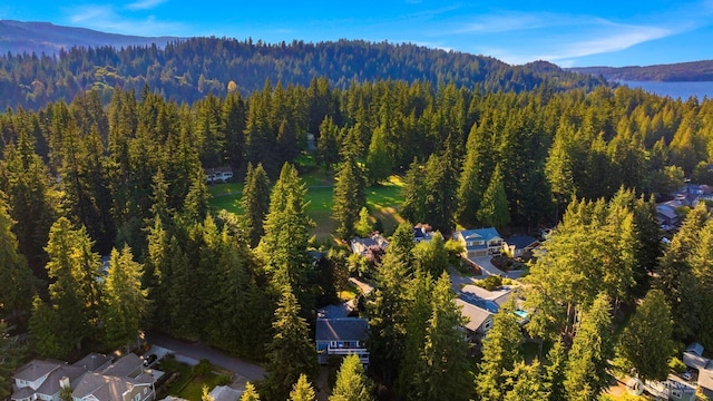 birds eye view of property with a wooded view