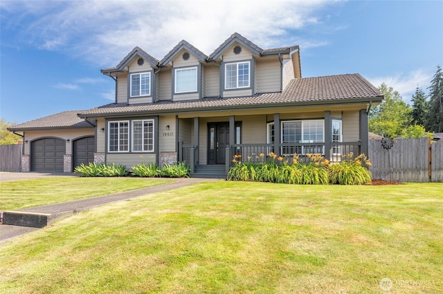 view of front of property with covered porch, a tile roof, fence, and a front lawn