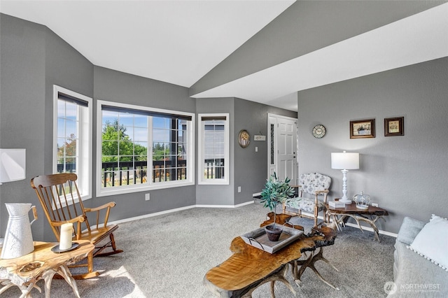 carpeted living area featuring vaulted ceiling and baseboards