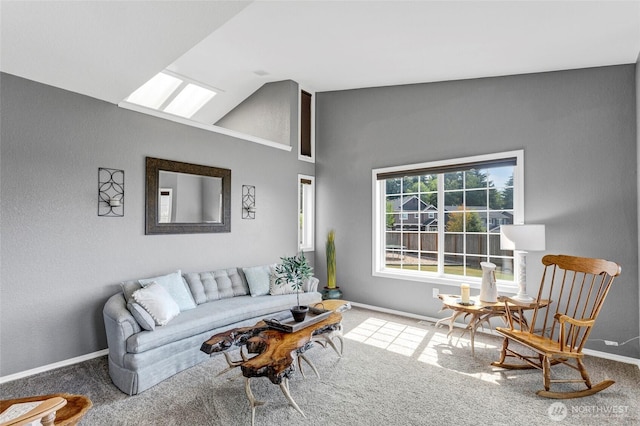 living area featuring lofted ceiling with skylight, baseboards, and carpet flooring