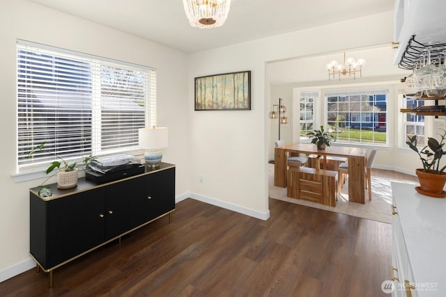 interior space featuring a chandelier, a wealth of natural light, and dark wood finished floors