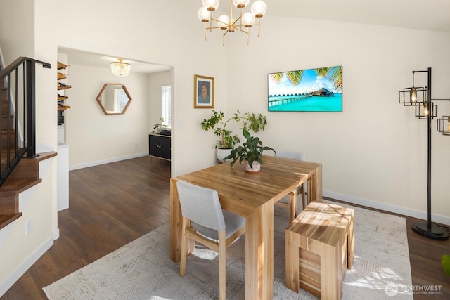 dining area with a notable chandelier, stairway, vaulted ceiling, wood finished floors, and baseboards