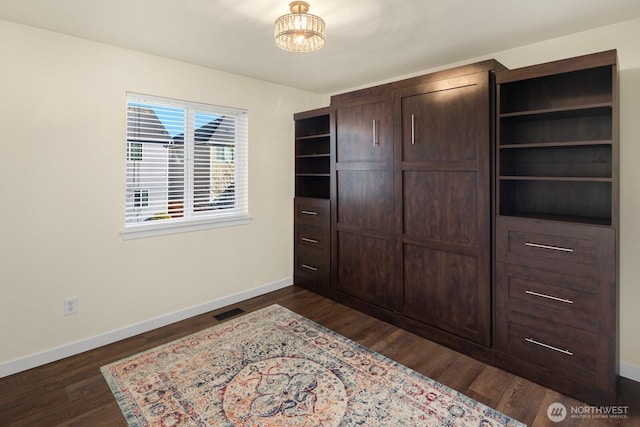 bedroom featuring dark wood-style floors, visible vents, and baseboards