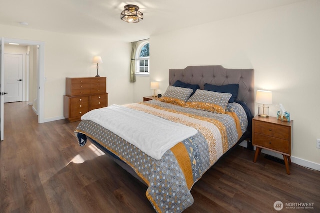 bedroom featuring baseboards and wood finished floors