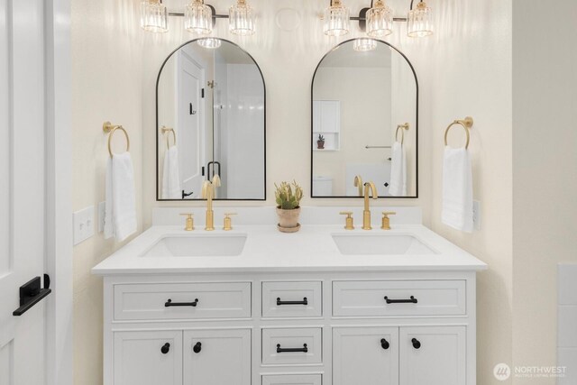 full bathroom with double vanity and a sink