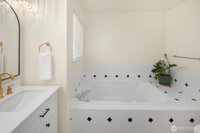 bathroom with a garden tub and vanity