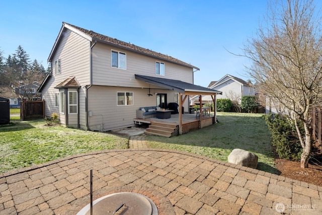 rear view of house featuring a patio area, fence, and a lawn