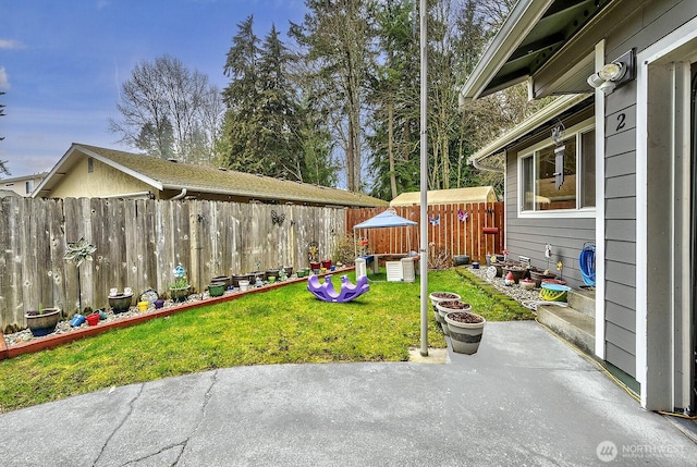 view of yard featuring a patio and fence