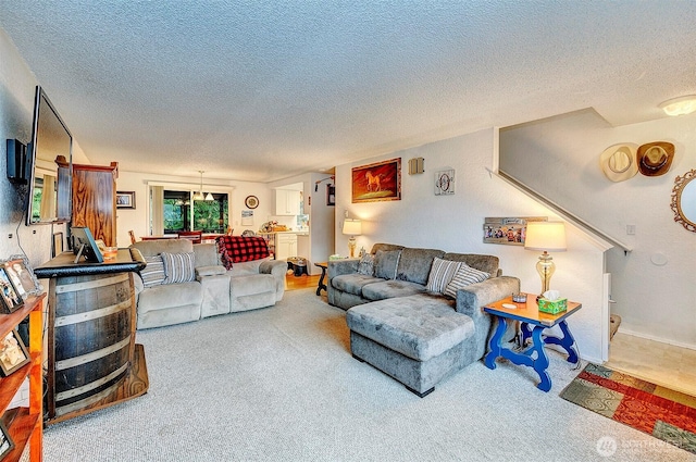 living area with a textured ceiling and carpet