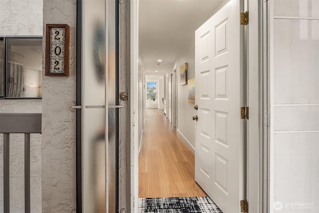 corridor featuring light wood-style floors