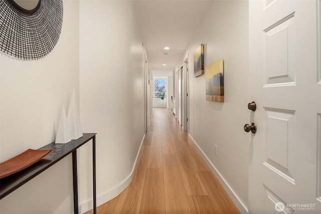 corridor with recessed lighting, baseboards, and light wood-style floors