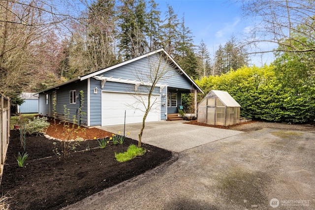 view of home's exterior featuring a greenhouse, a garage, and an outdoor structure