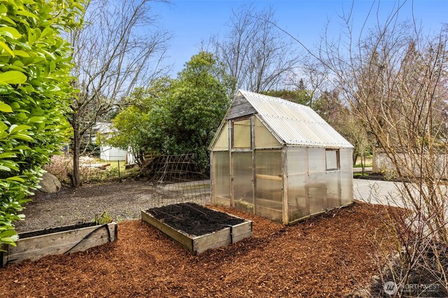 view of greenhouse featuring a vegetable garden