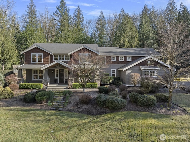 view of front of home with covered porch and a front yard