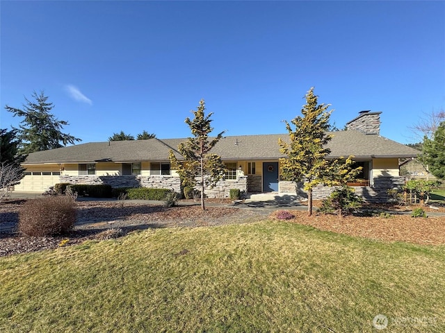 single story home with an attached garage, a chimney, and a front lawn