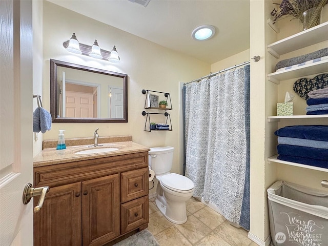 bathroom featuring a shower with curtain, vanity, toilet, and tile patterned floors