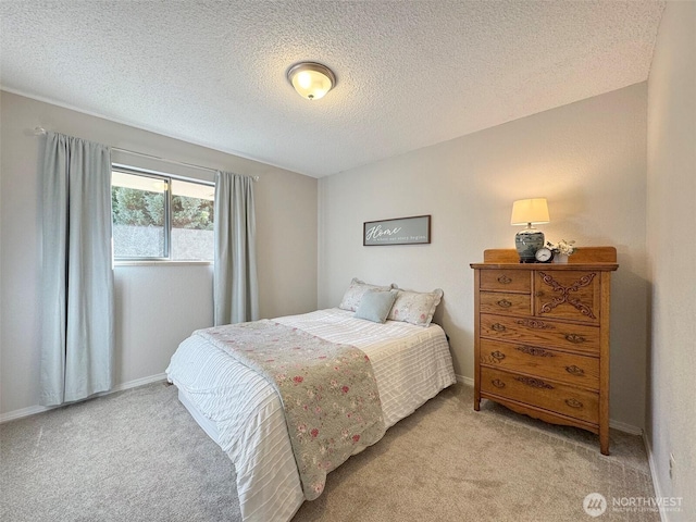 bedroom featuring baseboards, a textured ceiling, and light colored carpet