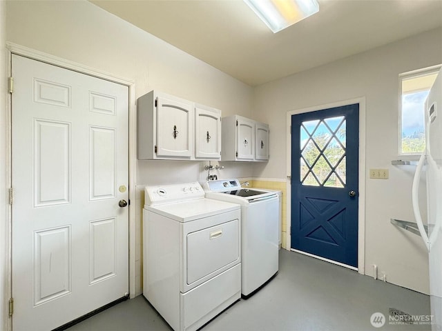 laundry room with independent washer and dryer and cabinet space