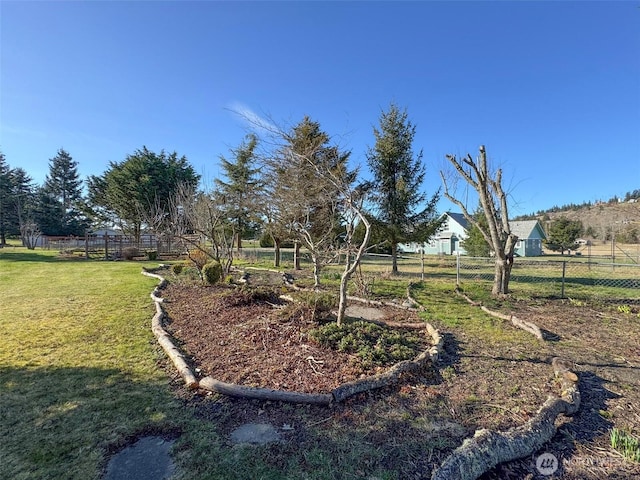 view of yard with a rural view and fence