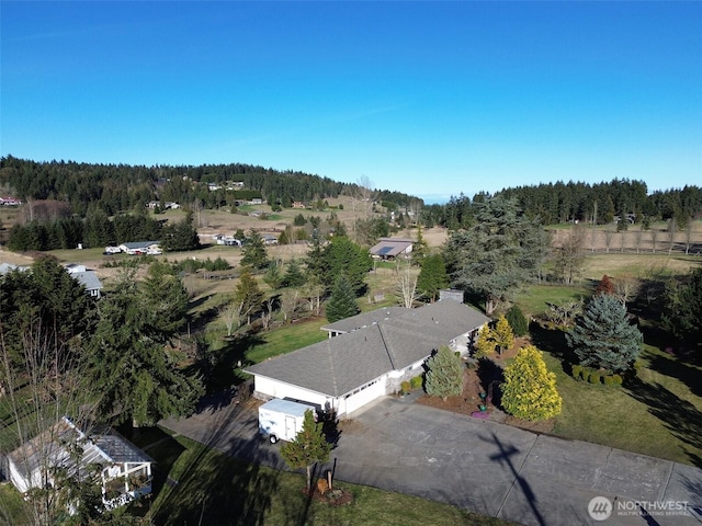 birds eye view of property with a wooded view