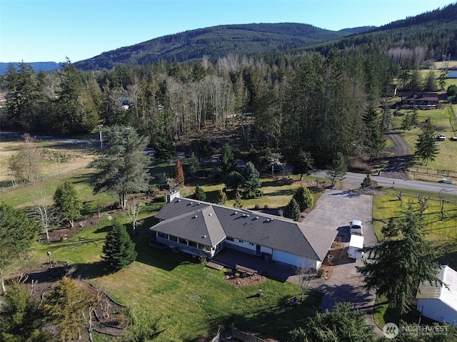 bird's eye view featuring a wooded view and a mountain view