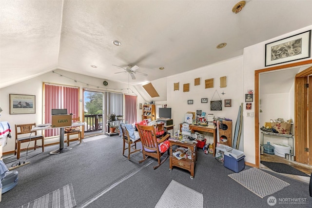 interior space with a textured ceiling, carpet, baseboards, ceiling fan, and vaulted ceiling