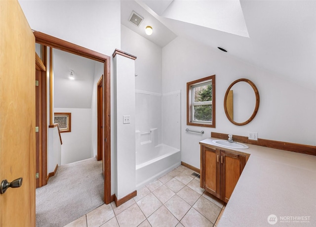 bathroom featuring tile patterned floors, visible vents, lofted ceiling, and vanity