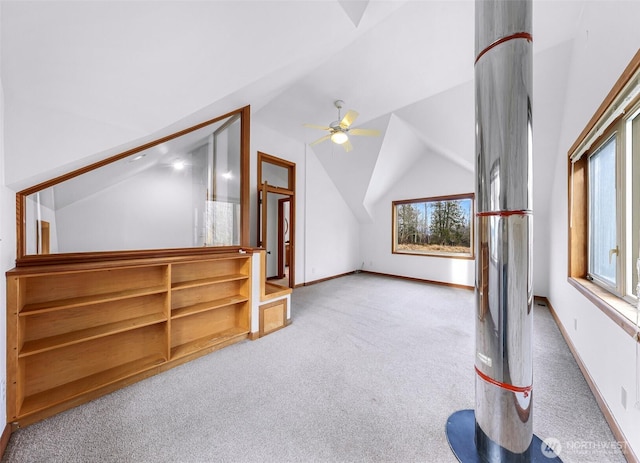 additional living space featuring baseboards, lofted ceiling, carpet, and a ceiling fan