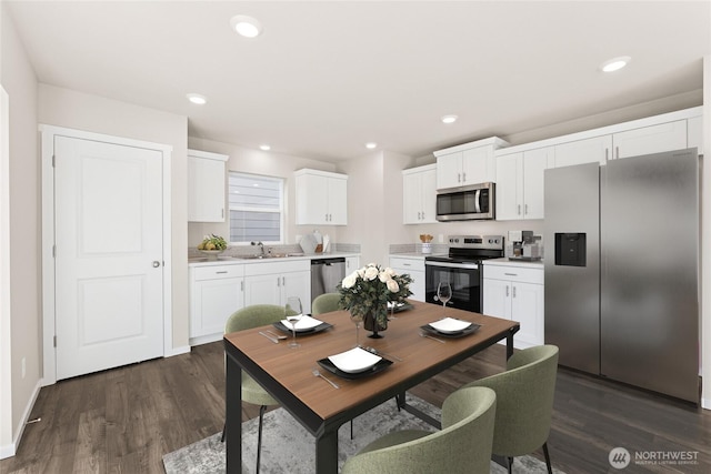 dining area with recessed lighting, dark wood finished floors, and baseboards