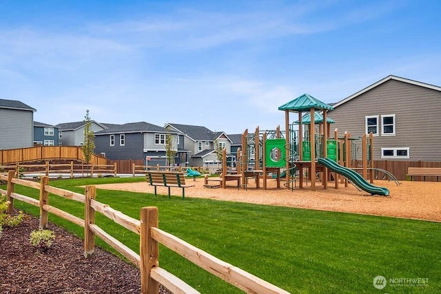 community playground with a lawn, fence, and a residential view